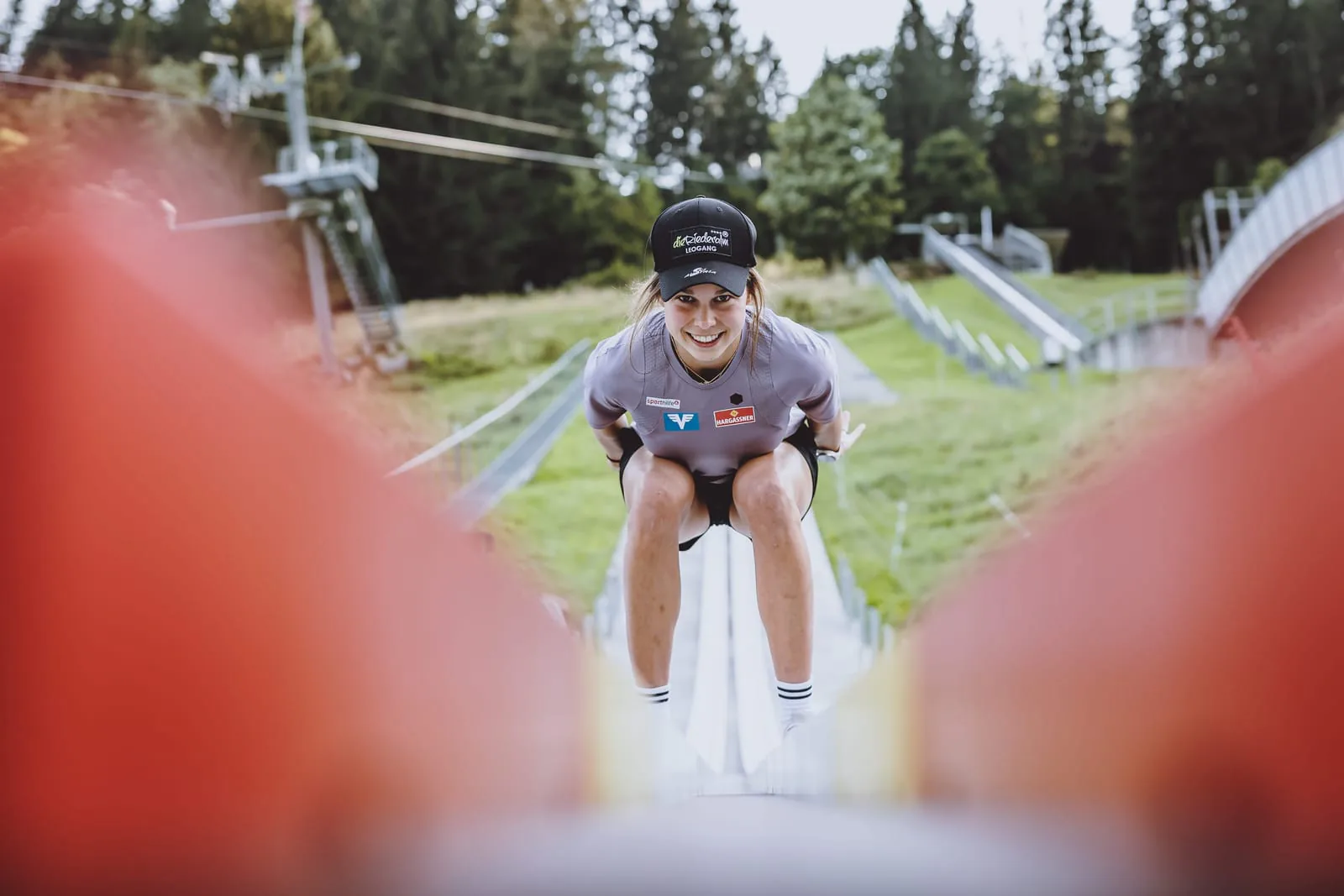 Athletin in Hockposition hinter der Spurbegrenzung der CLUBTRACK Anlaufspur